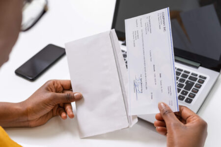 person getting paycheck - FICA tax withheld