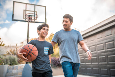 dad and son playing basketball