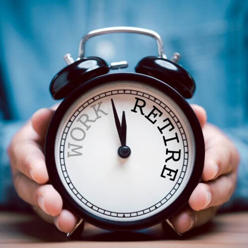 man holding retirement clock